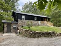 Front of home with a view of the outside entrance to the bonus room in basement.