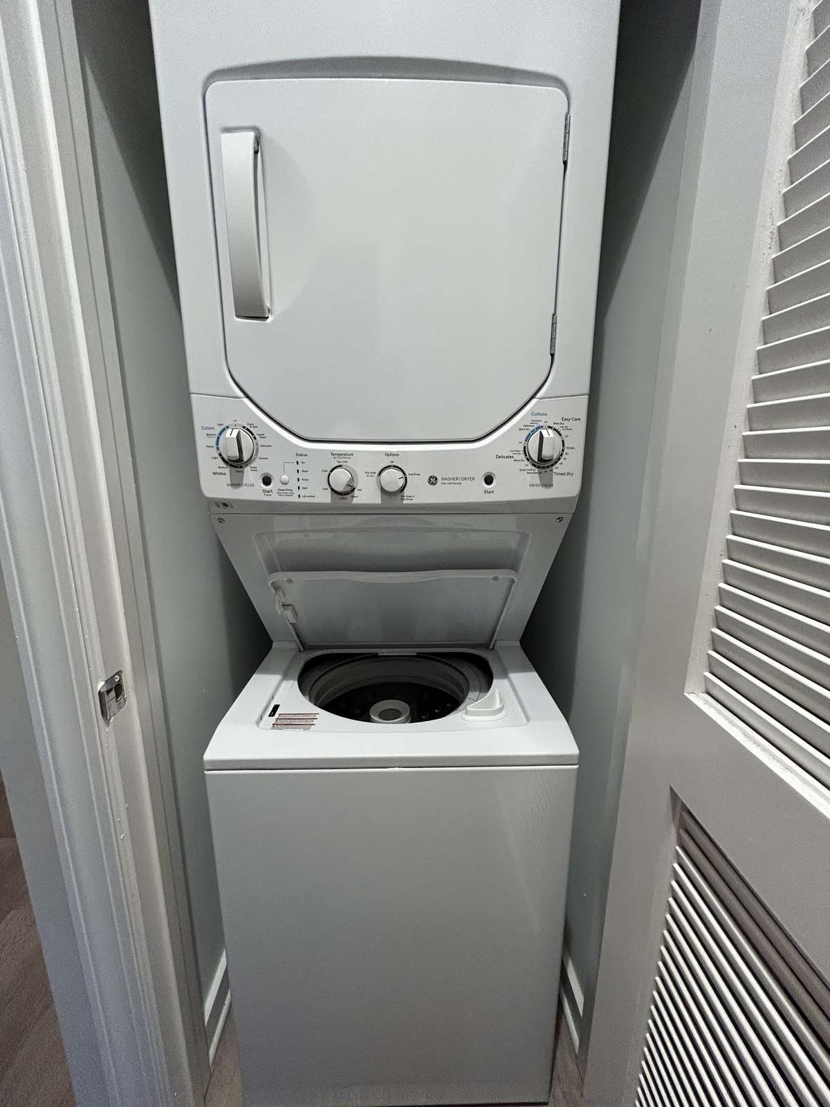 Just across from the bedroom, a stacked washer and dryer.