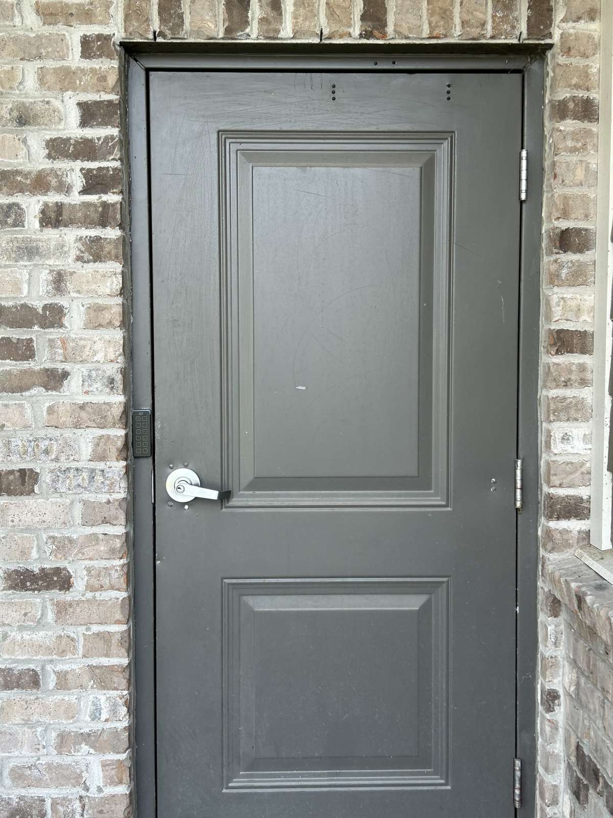 The entry into the building on the front. The keypad is to the left of the door.