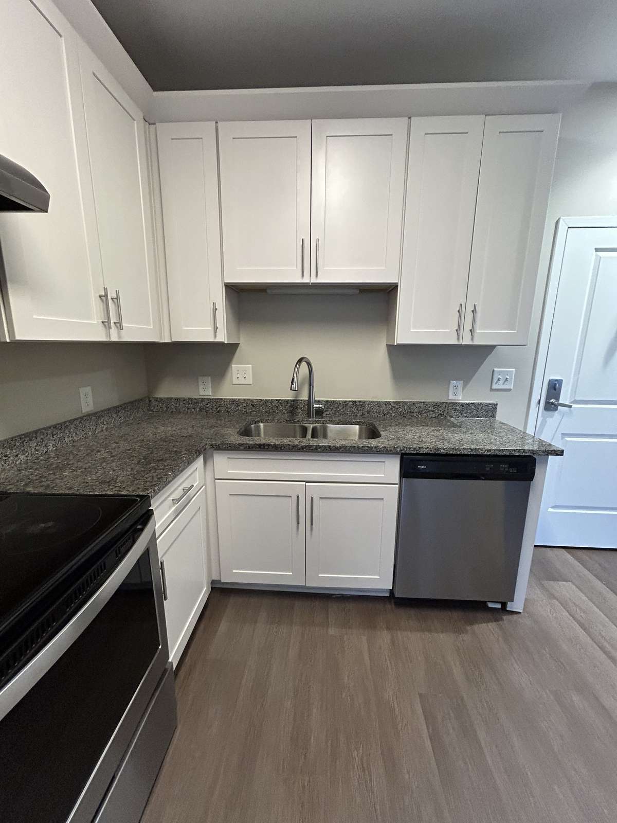 Just inside the front door, the well-equipped kitchen is in neutrals that will blend with any decor.