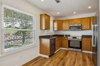 The warm and inviting Kitchen features granite counters and all new stainless steel appliances.
