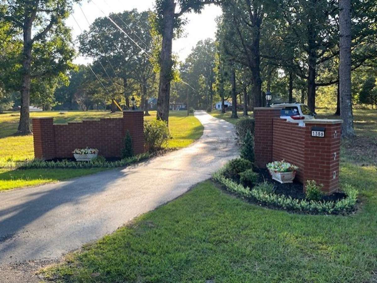 All brick landscaped stately entrance.