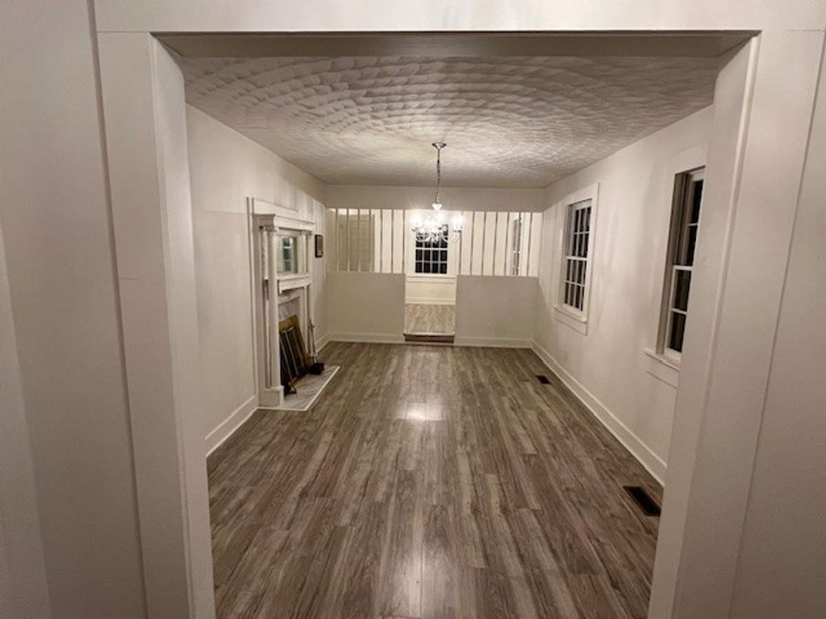 Foyer down to the Formal Living room and then step up to Dining Room. Antique/Mirrored elegant mantle to the left