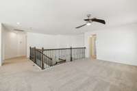 Large loft area with ceiling fan. A great work space or sitting area.