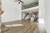 Loft upstairs overlooks the living room. Ornamental Iron spindles line the entire staircase and loft area.