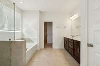 Primary Bathroom Suite #1 downstairs has a separate shower and tub, a water closet and double vanity.