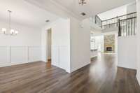 Enter into oversized foyer and formal dining room on the left. Butler's walk-through & pantry between dining room and kitchen.