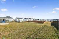 Back yard view looking out over the grass knoll.  No home directly behind yours!!