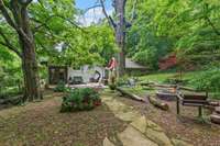 Stone path leads from the deck to the fire pit
