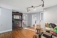 Den with original fireplace mantel