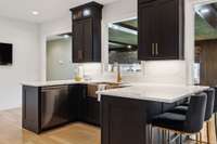 Custom cabinetry with under cabinet lighting and quartz counters