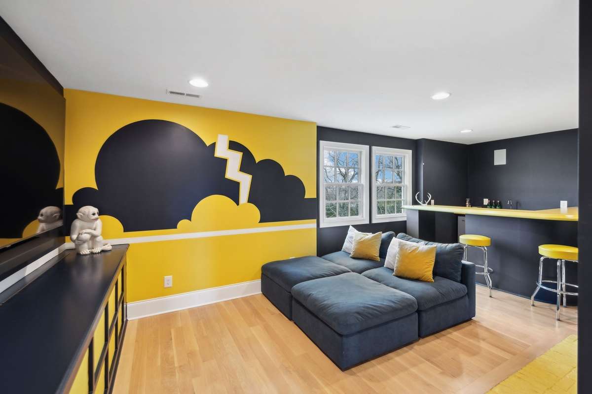 Lounge with bar and fireplace off the entry to the primary bedroom.
