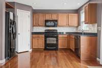 A tighter look at this modern kitchen offering Walk In Pantry.  All kitchen appliances remain as well.