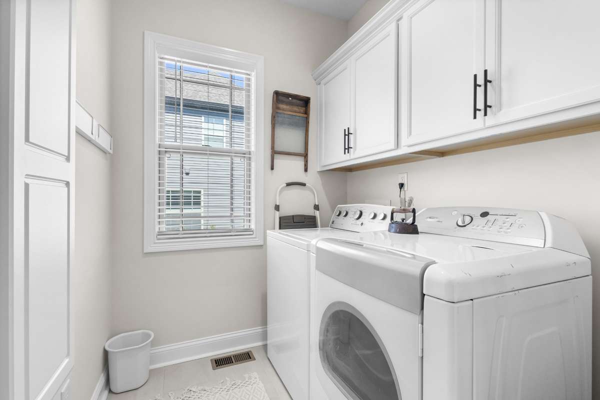 UTILITY ROOM  W/ IN-WALL IRONING CENTER & WALL MOUNTED DRYING RACK