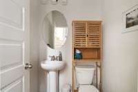 1/2 bath is tucked away from the living area to ensure guest comfort