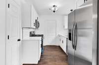 Stainless steel appliances + modern lighting