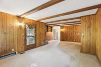 A side door to the patio leads off the den