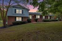 Twilight view of this classic split-level home on over 1 acre ON THE GOLF COURSE!