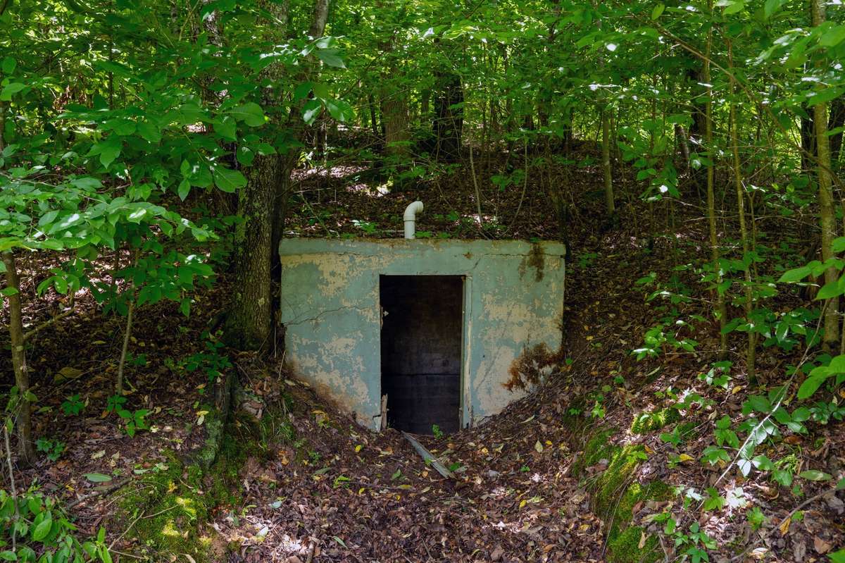 Storm shelter build into hillside just outside of house.