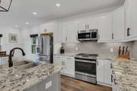 Kitchen upgrades include SS Appliances, granite countertops and custom cabinets.