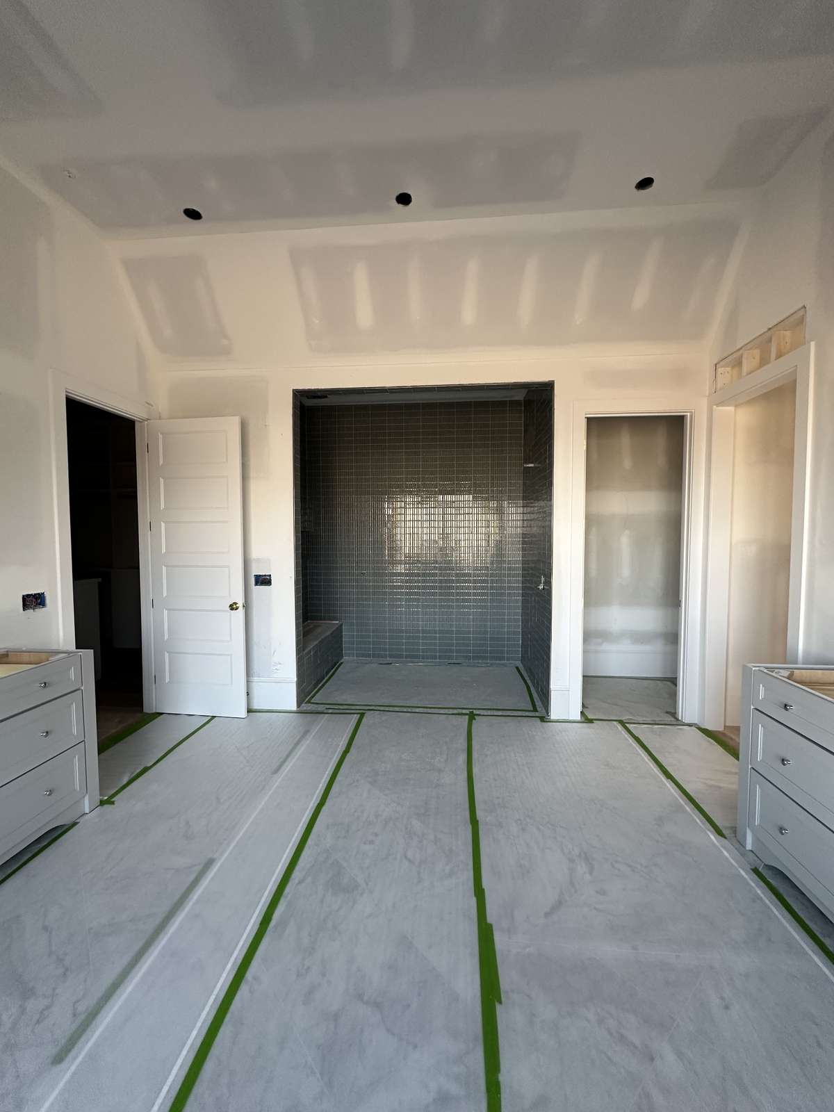 Primary bath with separate vanities, walk-in closets, a soaking tub, and shower.

*This home is under construction. Photo updated 2/20/26.