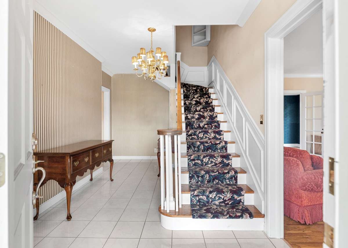 Entrance Hallway, tiled flooring and  Trendy wall coverings create a Lavish Flair
