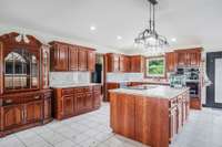 Open Concept Kitchen with dark wood cabinets and loads of counter space!