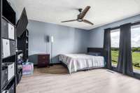 Guest Bedroom #1, updated flooring and large windows.