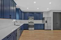 The custom cabinets, abundant counter space, and stainless appliances make for a well appointed kitchen.