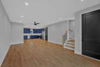 A view of the living area toward the  staircase and kitchen.