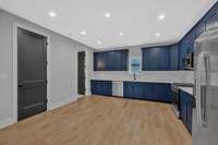 The doors on the left conceal a storage closet and a half bath.