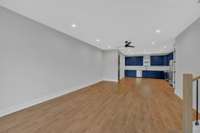 A view of the spacious open floor plan across the living area toward the kitchen.