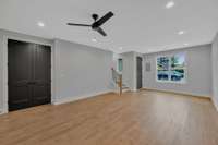A view of the living area from the kitchen looking toward the front door.  The double doors on the left conceal an oversized pantry.