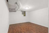 This room has a finished floor where the remainder of the basement only offers a concrete floor.