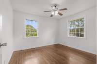 Bedroom two with a larger closet and a ceiling fan.