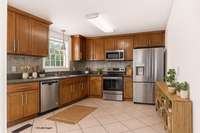 Your kitchen allows enough room for adding an island or a separate prep counter on the right hand wall.