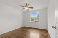 Bedroom three still offers wood floors and a ceiling fan.