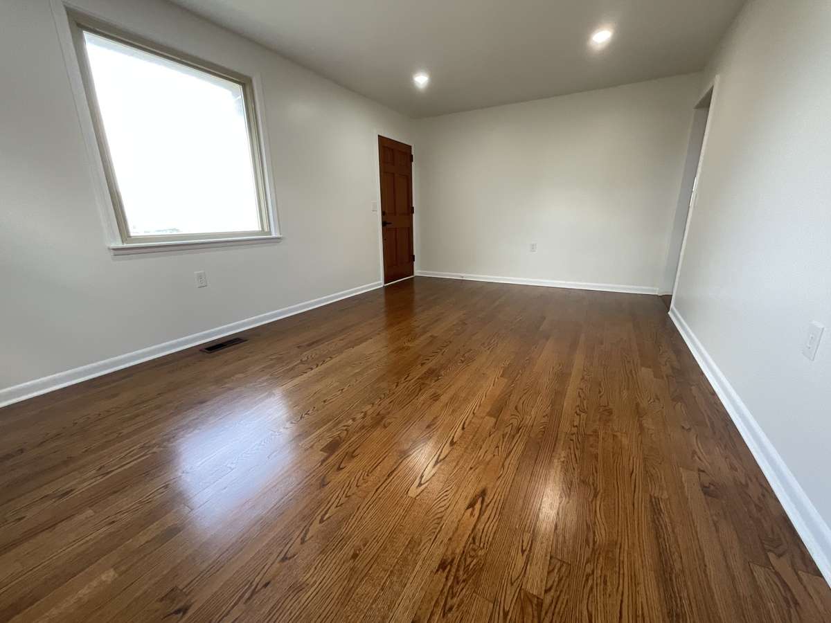 Look at the natural light and the shine on this freshly refinished living room floors.