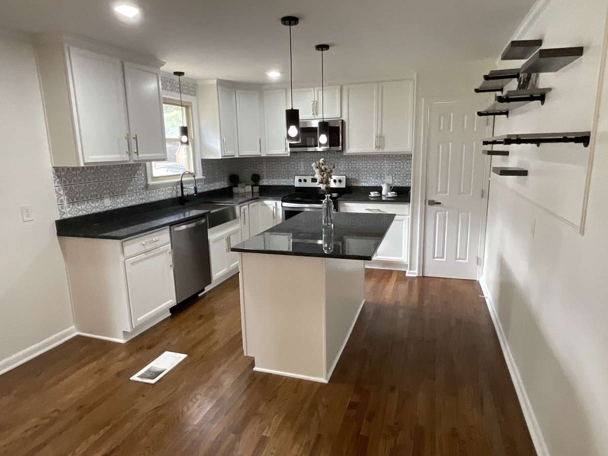 Totally updated kitchen with easy close drawers, farm sink and large island makes this kitchen a 10 .