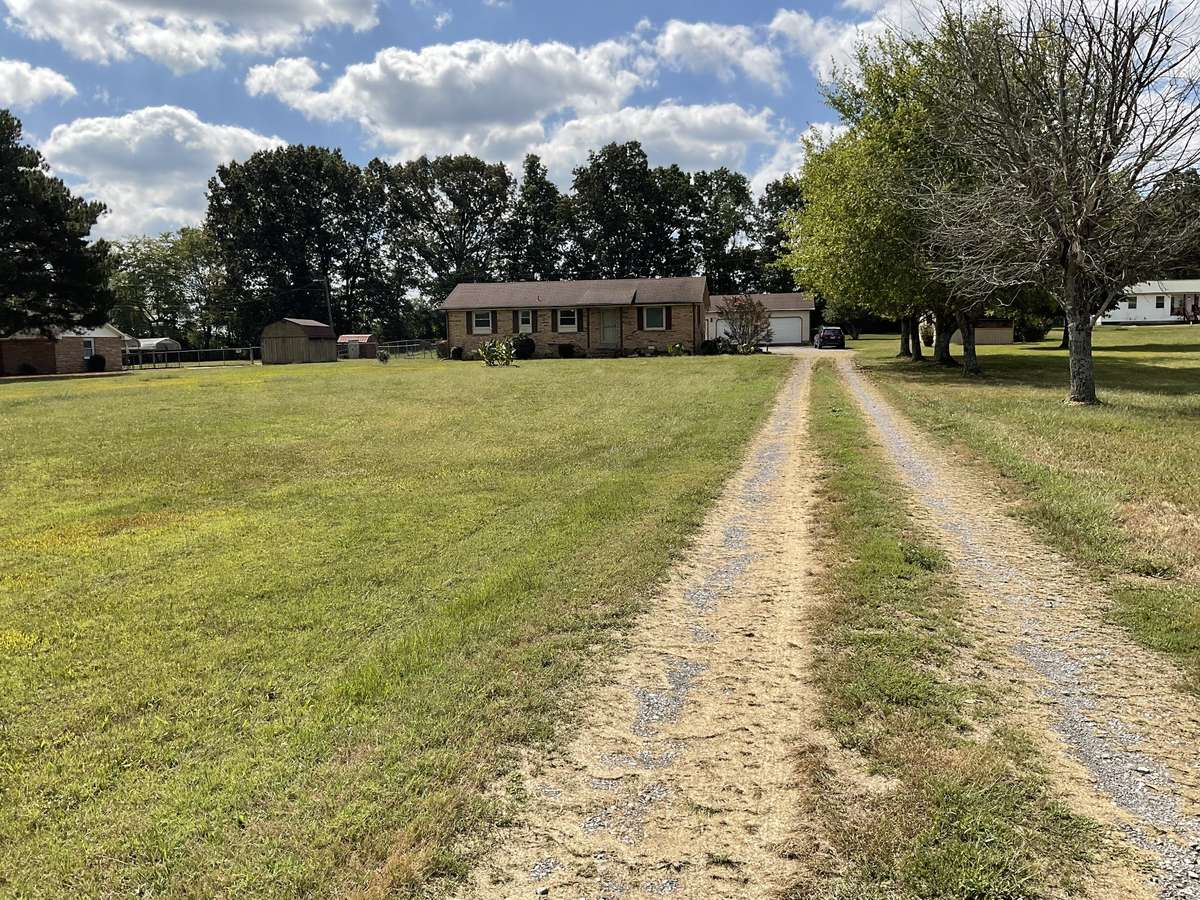 Home nestled off the road with large detached shop with electricity and gas heat.