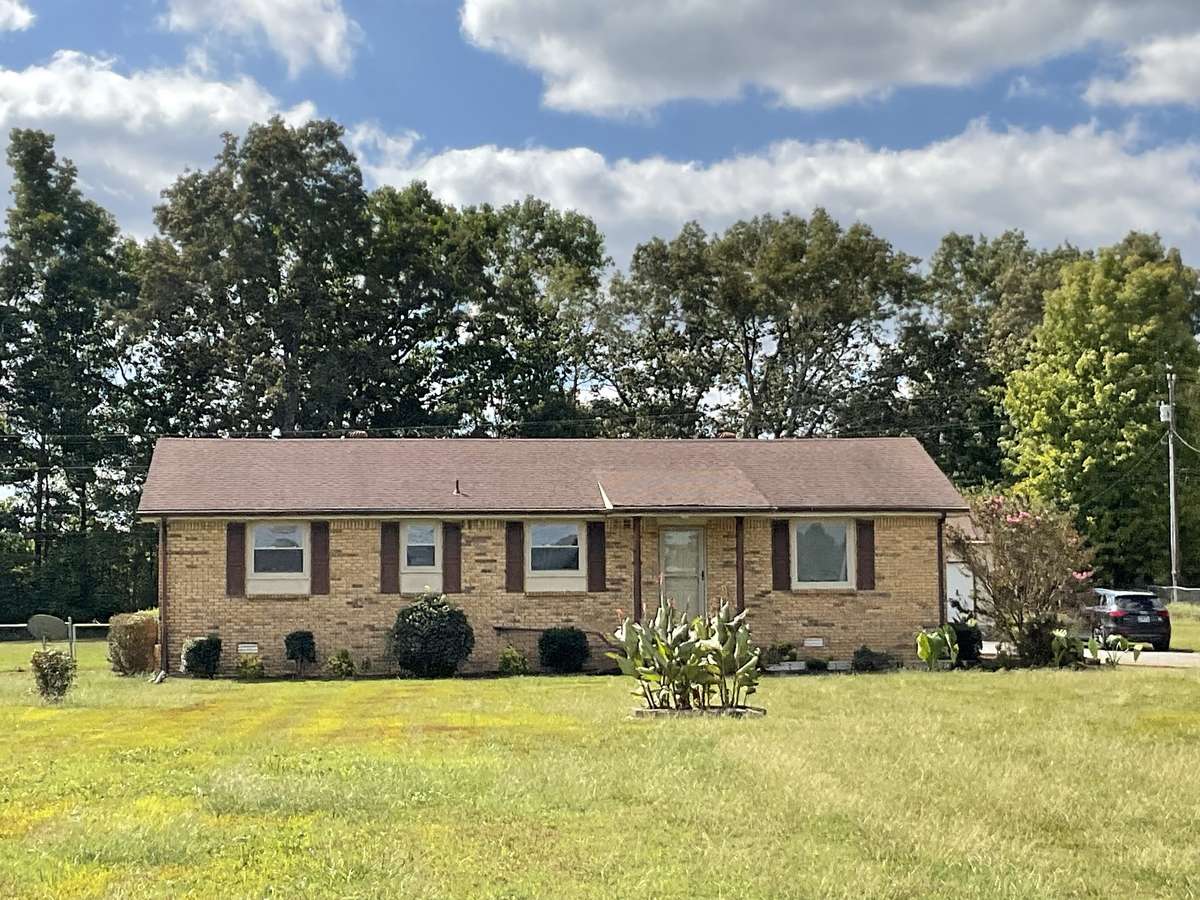 All brick home on level 1.71 acre lot. this is a 3 bedroom 2 bath home with a detached 2 car shop and 2 storage buildings that convey