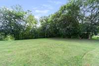 mostly level backyard. Put a shop/garage here