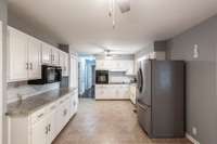 The spacious eat-in kitchen features generous cabinetry, granite countertops, and exceptional storage throughout.