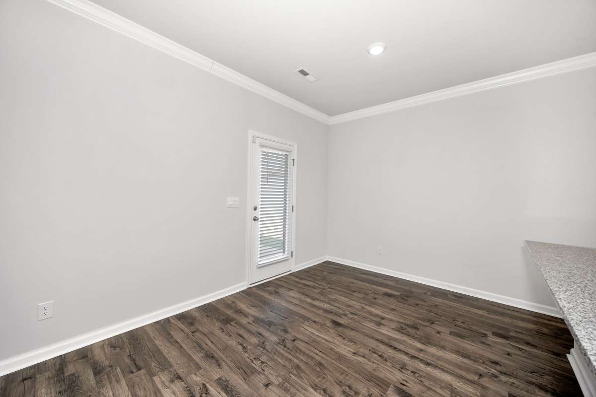 Kitchen/Dining Area- lvp flooring, open floorplan, granite countertops, kitchen island with bar seating, pantry, stainless steel appliances- refrigerator, microwave, oven. cooktop