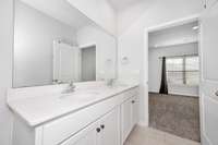 Primary Bath- Tile flooring, double vanities, recessed lighting