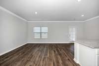 Living Room- Lvp flooring, crown molding, recessed lighting, open floorplan