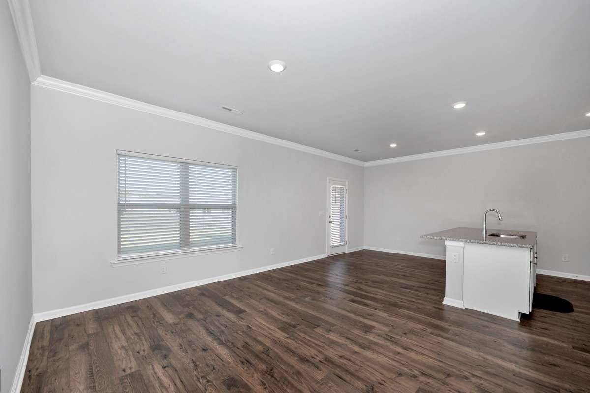Living Room- Lvp flooring, crown molding, recessed lighting, open floorplan