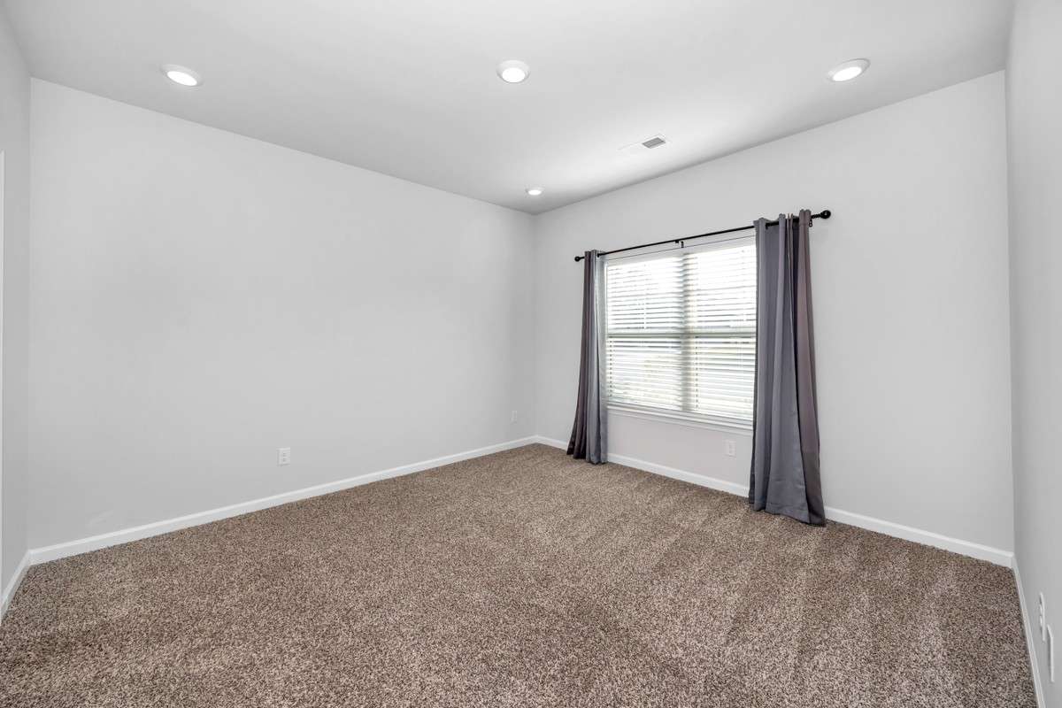 Primary Bedroom- Carpet, recessed lighting, walk-in closet