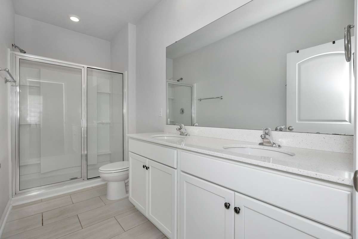 Primary Bath- Tile flooring, double vanities, recessed lighting