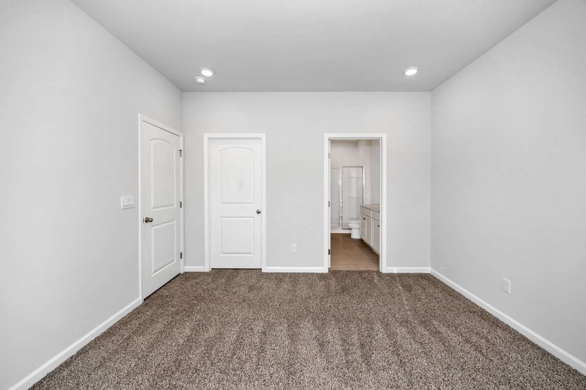 Primary Bedroom- Carpet, recessed lighting, walk-in closet